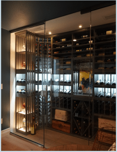 Transitional Wine Cellar: Glass-Enclosed Door and Wooden Wine Racks
