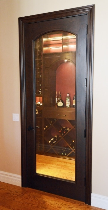 The Custom Wine Cellar Door Complements the Wood Wine Racks
