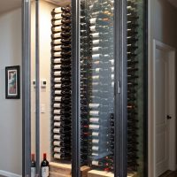 2 - Modern Glass Wine Cellar with Elegant Racking Features Glass Wine Cellar in Orange County