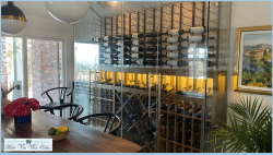 9 - Frameless Glass Protects and Displays the Wine Collection elegant glass wine wall with wooden wine racks and metal wine racks